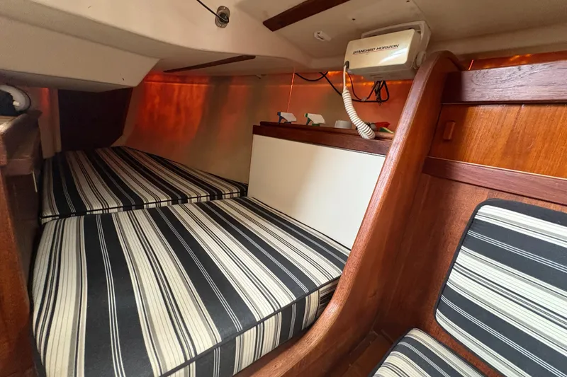 Slide: The Image of Interior cabin of 1981 Sabre 31 sailboat with striped cushions and wooden accents. - 83