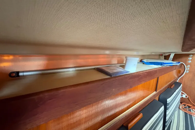 Slide: The Image of Interior of 1981 Sabre 31 sailboat with wooden shelves and nautical items. - 85
