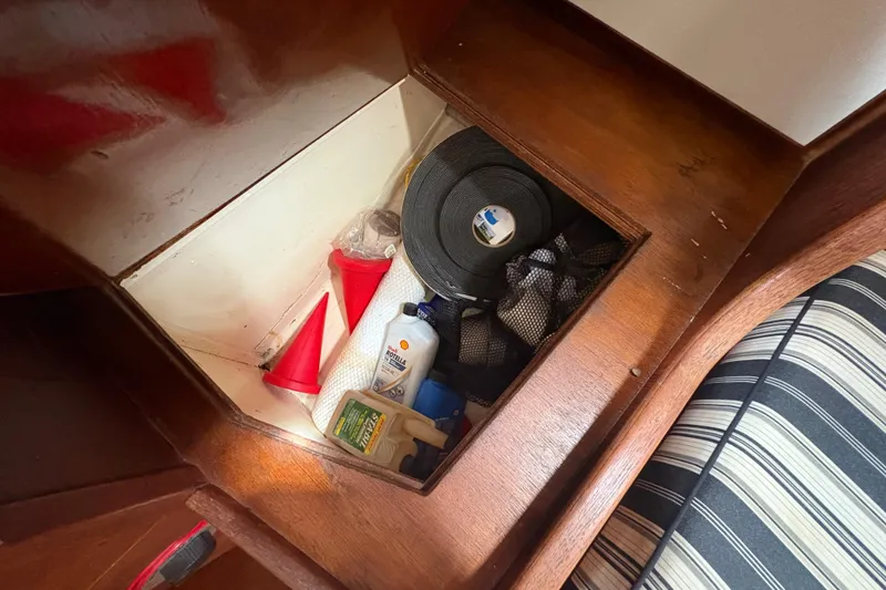 Slide: The Image of Storage compartment in 1981 Sabre 31 sailboat with tools and supplies. - 87
