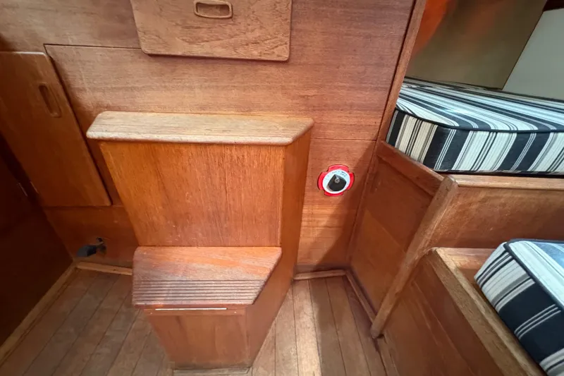 Slide: The Image of Interior of 1981 Sabre 31 sailboat with wooden cabinetry and striped cushions. - 88