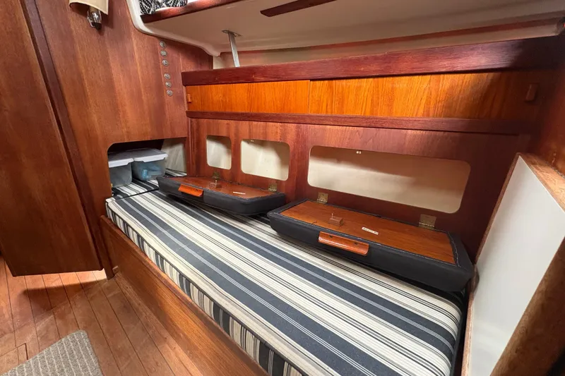 Slide: The Image of 1981 Sabre 31 interior with striped cushions and wooden cabinetry. - 93