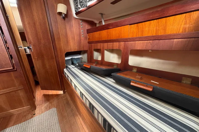 Slide: The Image of Interior of 1981 Sabre 31 sailboat with wooden finish and striped seating. - 94