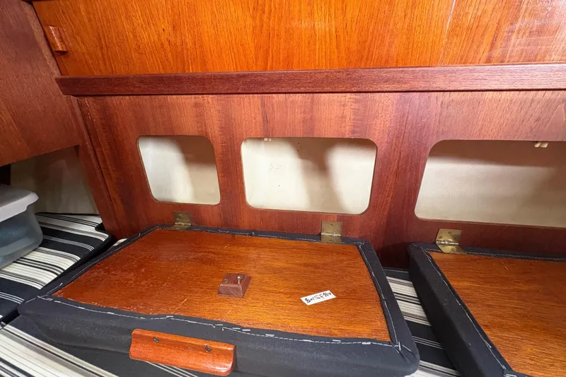 Slide: The Image of Interior of 1981 Sabre 31 sailboat with wooden cabinetry and striped cushions. - 95