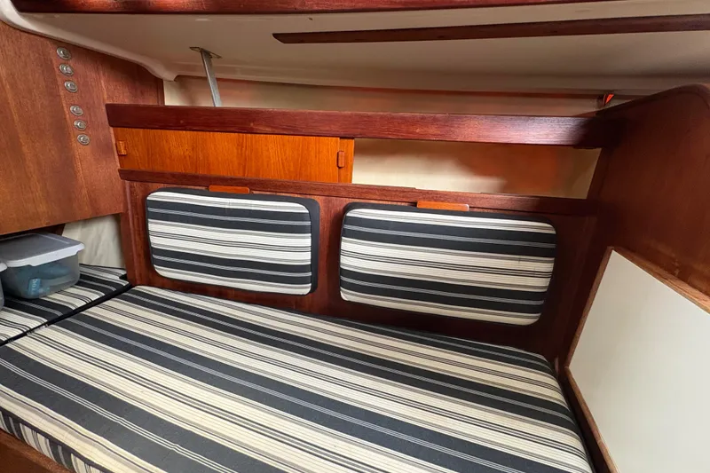 Slide: The Image of Interior of 1981 Sabre 31 sailboat with striped cushions and wooden cabinetry. - 96