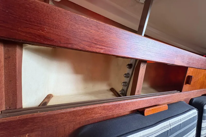 Slide: The Image of Interior storage compartment of a 1981 Sabre 31 sailboat with wooden finish. - 98