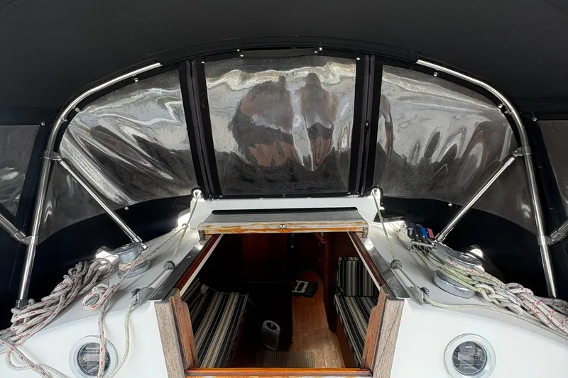 Slide: The Image of 1981 Sabre 31 sailboat deck view, docked among other boats. - 13