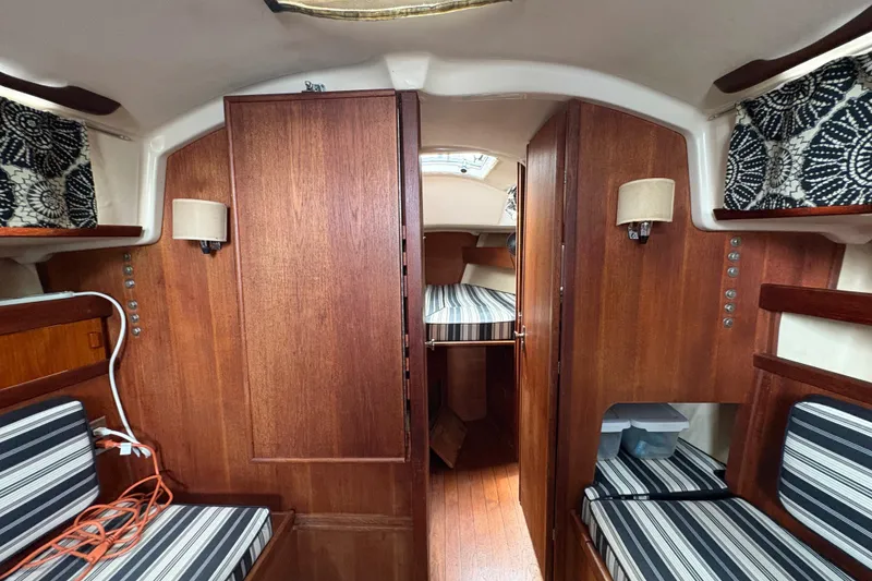 Slide: The Image of Cockpit of 1981 Sabre 31 sailboat docked at marina, featuring winches and covered helm. - 16