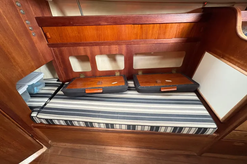 Slide: The Image of Cockpit of 1981 Sabre 31 sailboat docked at marina, featuring cushioned seating and steering wheel. - 19