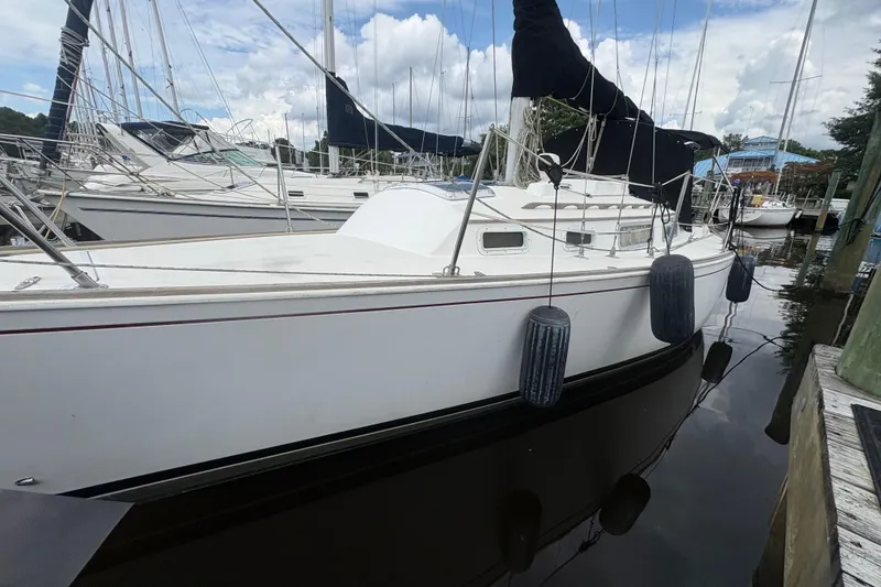 Slide: The Image of 1981 Sabre 31 sailboat docked at marina, surrounded by other boats. - 2