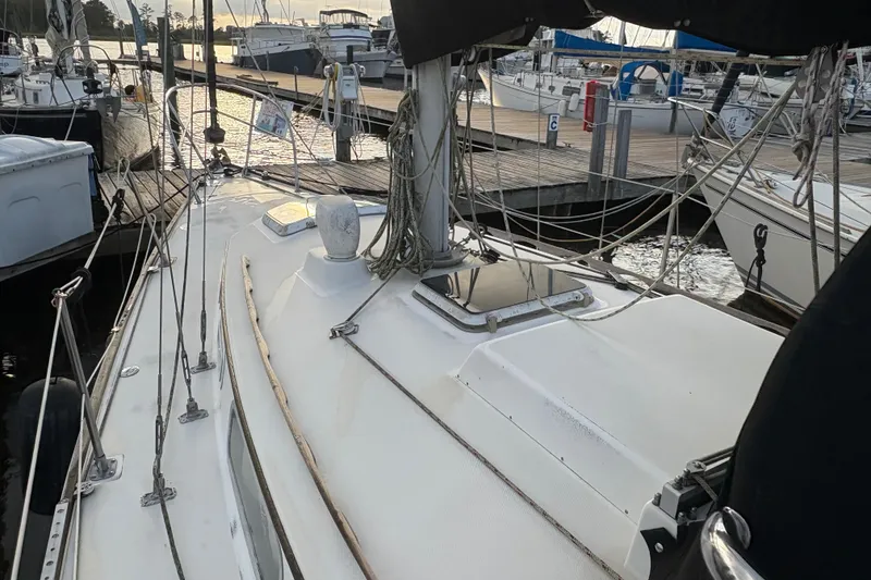 Slide: The Image of Interior of 1981 Sabre 31 sailboat with striped cushions and patterned curtains. - 26