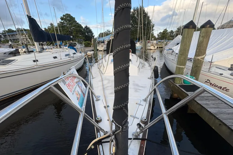 Slide: The Image of Interior of a 1981 Sabre 31 sailboat with wood cabinetry and patterned curtains. - 27