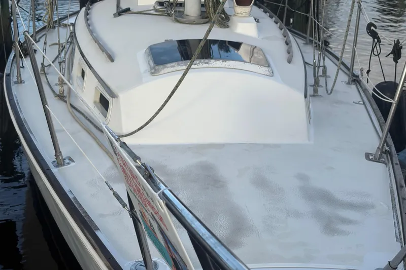 Slide: The Image of Interior of 1981 Sabre 31 sailboat with striped cushions and wooden paneling. - 28