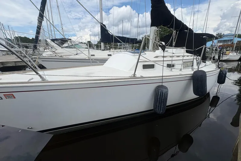 Slide: The Image of 1981 Sabre 31 sailboat named "Imagine" docked at a marina. - 3