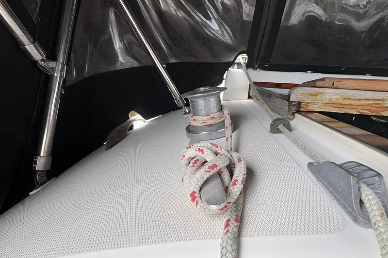 Slide: The Image of Wooden interior of 1981 Sabre 31 boat with a battery switch and striped cushion. - 54