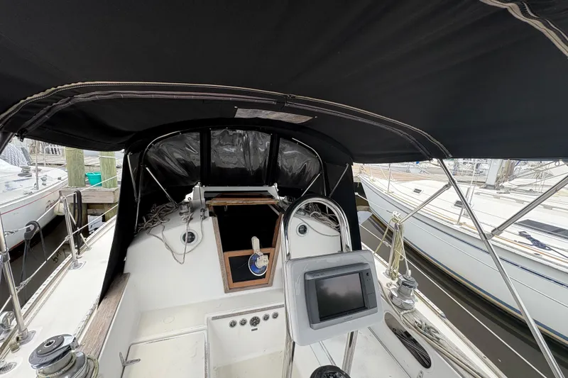 Slide: The Image of Storage area in 1981 Sabre 31 sailboat with plastic containers and striped cushion. - 57