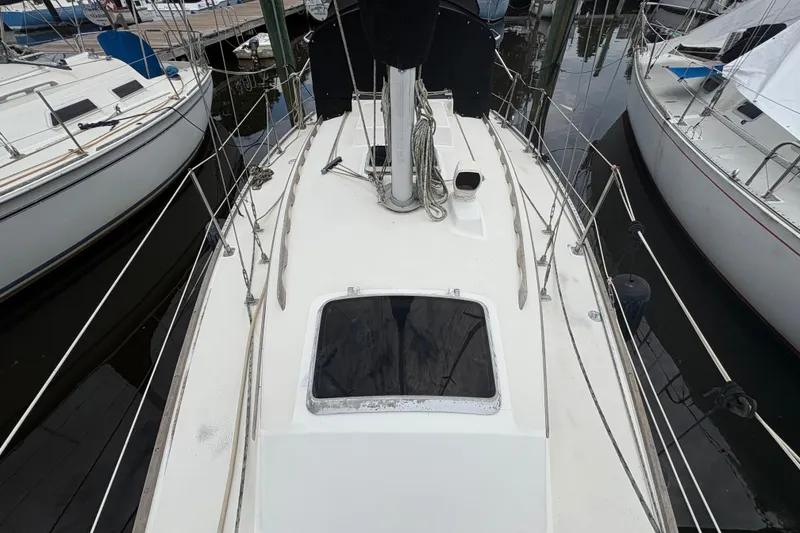 Slide: The Image of Interior of 1981 Sabre 31 sailboat with striped cushions and wooden storage compartment. - 59