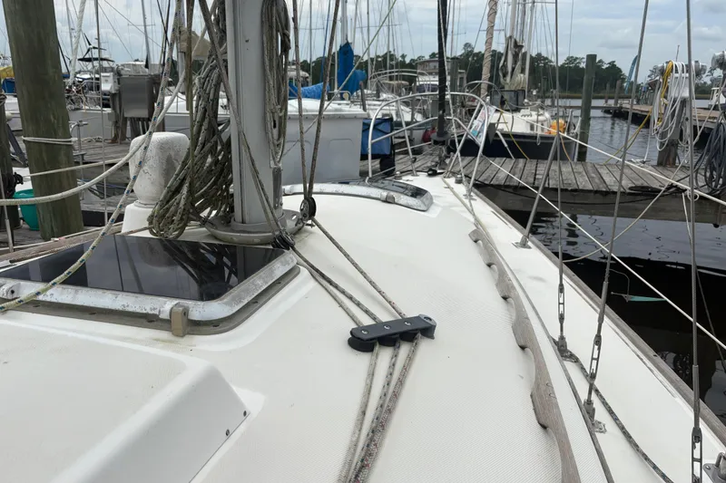 Slide: The Image of Interior of 1981 Sabre 31 sailboat with wooden paneling and a white door. - 65