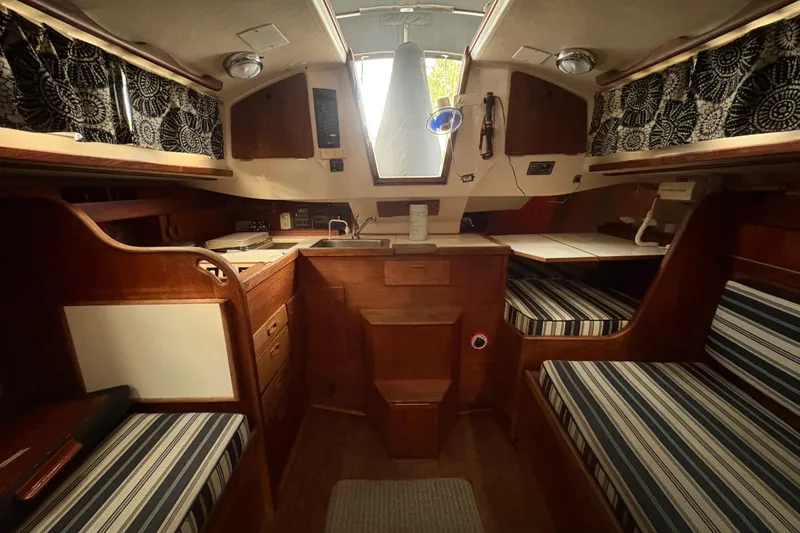 Slide: The Image of Engine compartment of a 1981 Sabre 31 sailboat, featuring a visible belt and pulley system. - 77