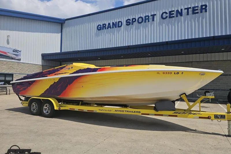 Slide: The Image of 2003 Sonic USA 31SS speedboat on trailer at Grand Sport Center, vibrant design. - 12