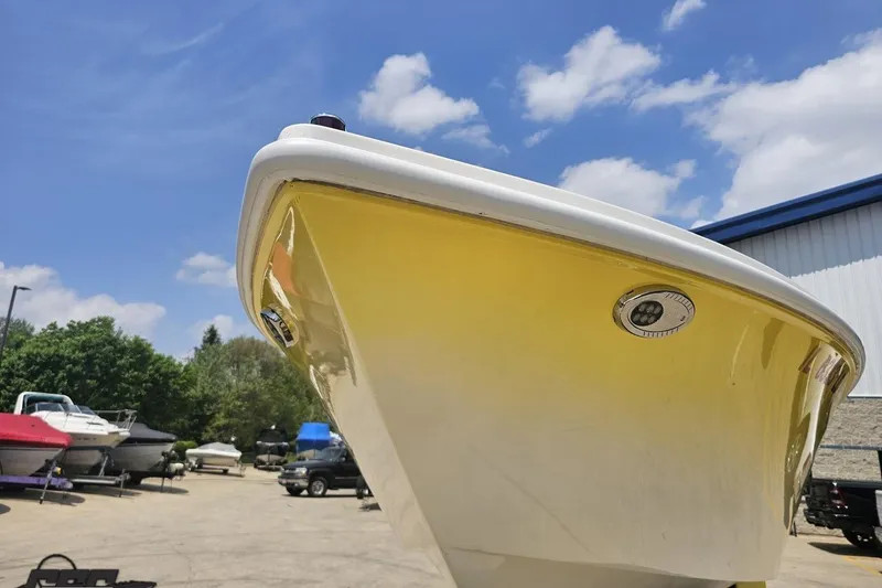 Slide: The Image of 2003 Sonic USA 31SS boat with yellow hull under a clear blue sky. - 14
