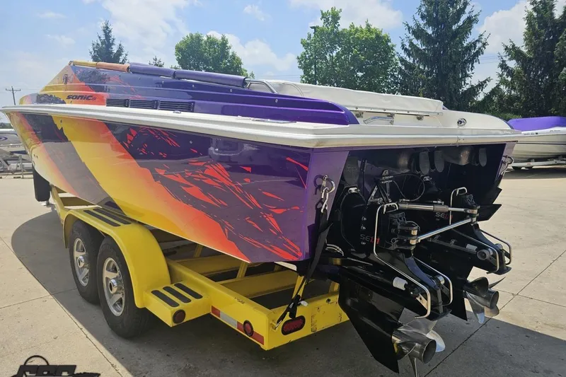 Slide: The Image of 2003 Sonic USA 31SS speedboat with vibrant graphics on a yellow trailer. - 25
