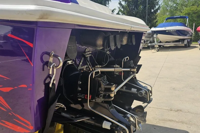 Slide: The Image of Rear view of a 2003 Sonic USA 31SS boat with visible engine components. - 26