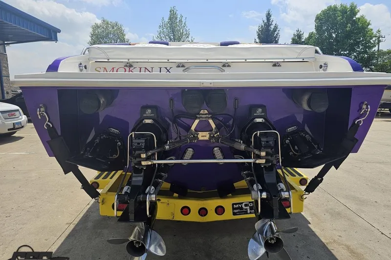 Slide: The Image of Rear view of a 2003 Sonic USA 31SS boat with dual Mercury engines. - 27