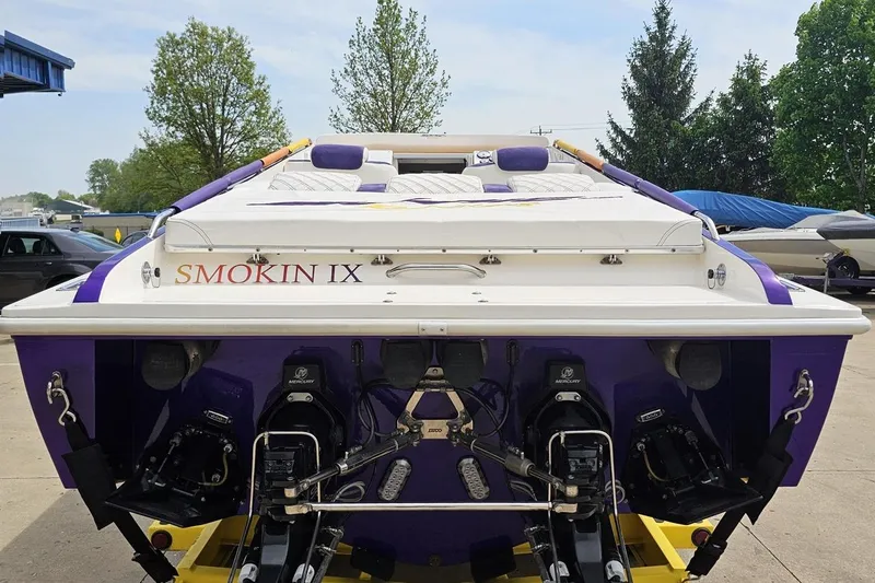 Slide: The Image of 2003 Sonic USA 31SS boat, rear view with dual Mercury engines, labeled "Smokin IX." - 29