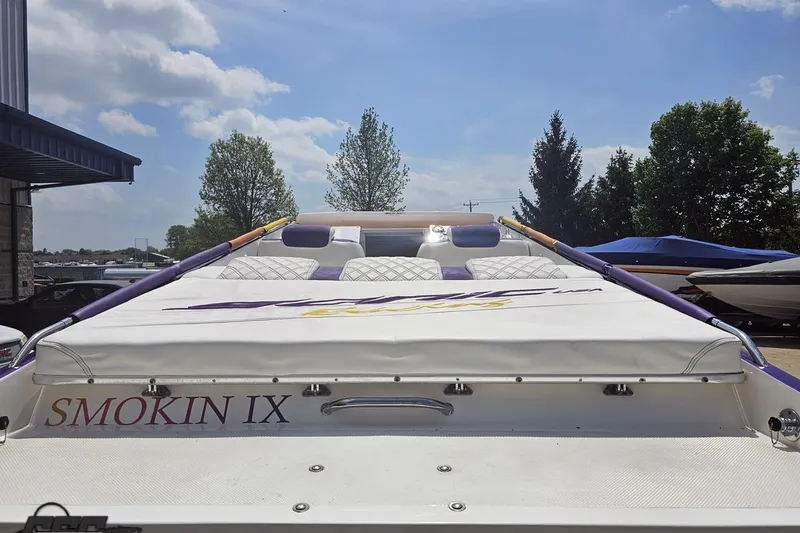Slide: The Image of 2003 Sonic USA 31SS boat, "Smokin IX," docked under a clear blue sky. - 30