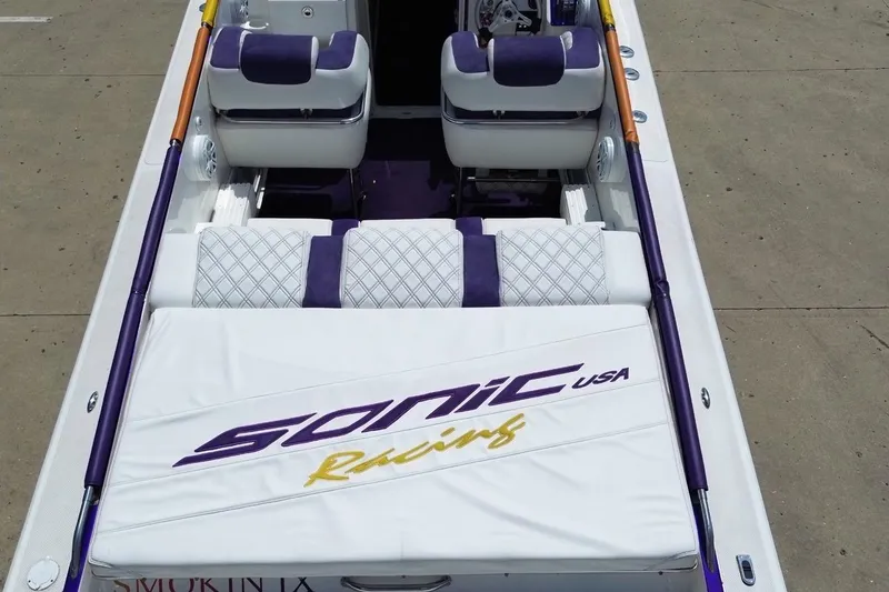 Slide: The Image of 2003 Sonic USA 31SS boat interior with purple and white seating, featuring "Sonic Racing" branding. - 34