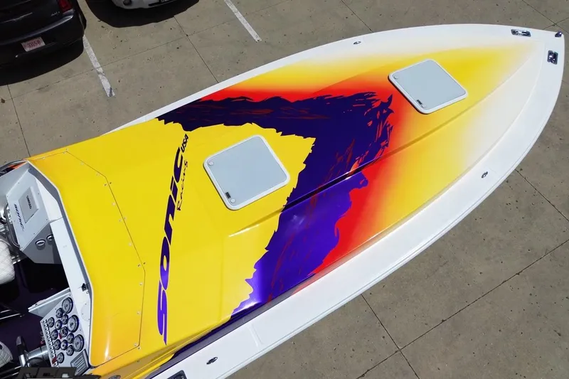 Slide: The Image of 2003 Sonic USA 31SS speedboat with vibrant yellow and purple graphics on deck. - 39
