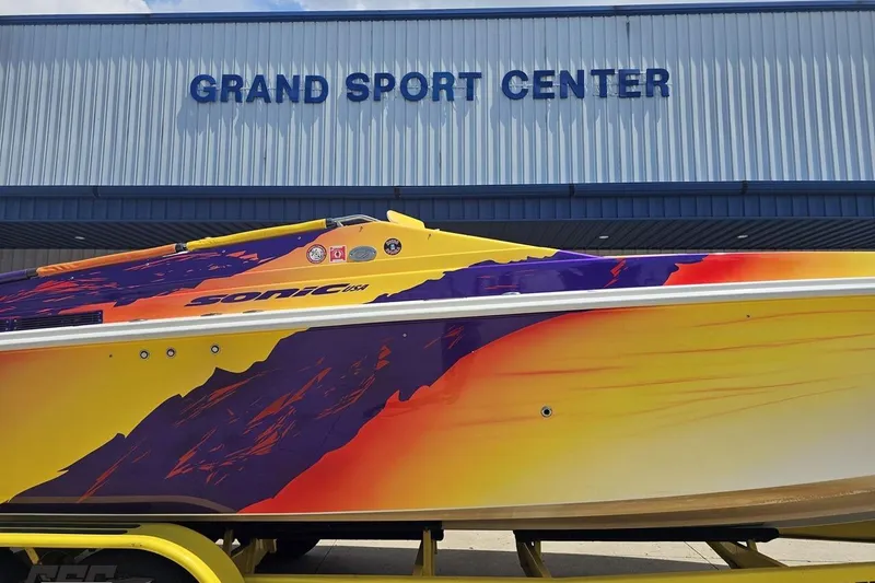 Slide: The Image of Colorful 2003 Sonic USA 31SS boat at Grand Sport Center. - 4