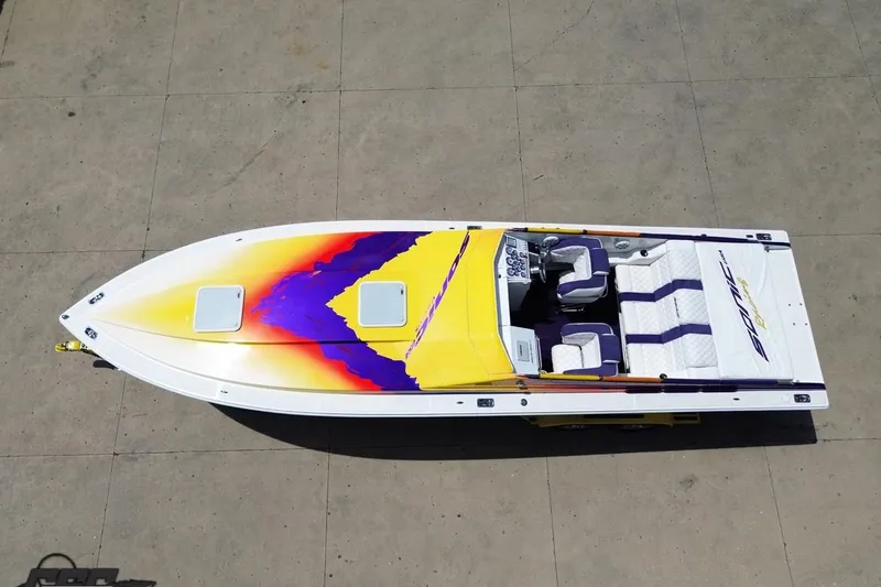 Slide: The Image of Aerial view of 2003 Sonic USA 31SS speedboat with vibrant yellow and purple design. - 41