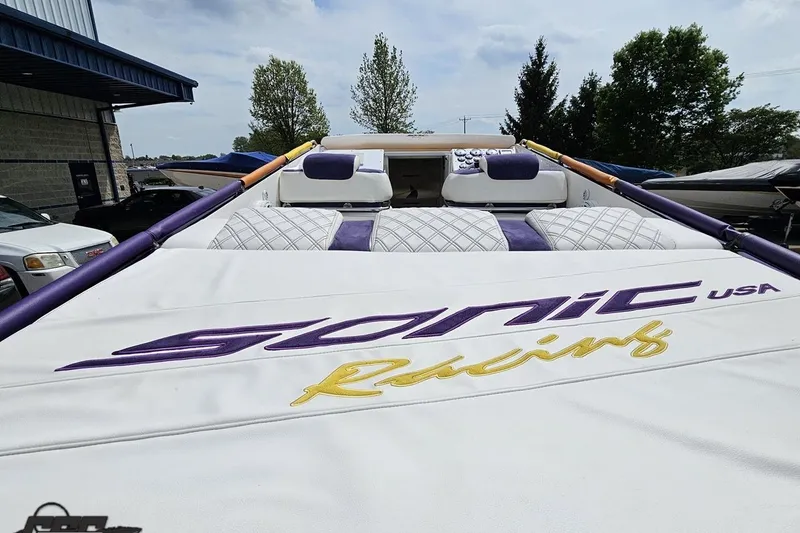 Slide: The Image of 2003 Sonic USA 31SS boat with custom racing upholstery, parked outdoors. - 42