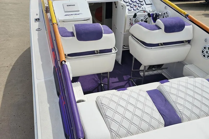 Slide: The Image of Interior of a 2003 Sonic USA 31SS boat with purple and white seating. - 44