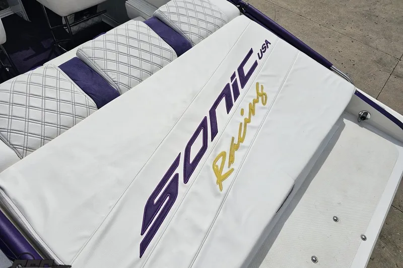 Slide: The Image of 2003 Sonic USA 31SS boat seat with embroidered logo in purple and yellow. - 45