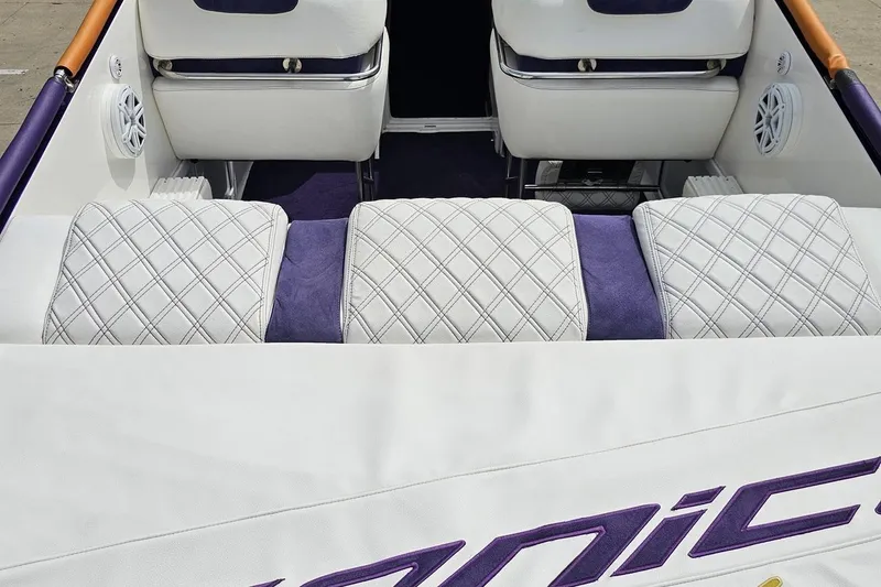 Slide: The Image of Interior of 2003 Sonic USA 31SS boat with white quilted seats and purple accents. - 48