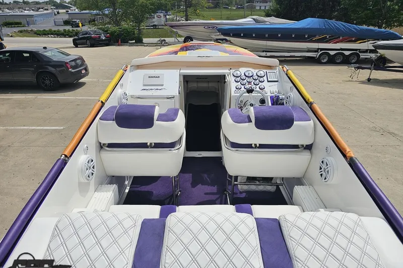 Slide: The Image of 2003 Sonic USA 31SS speedboat with purple and white interior, docked in a marina. - 50