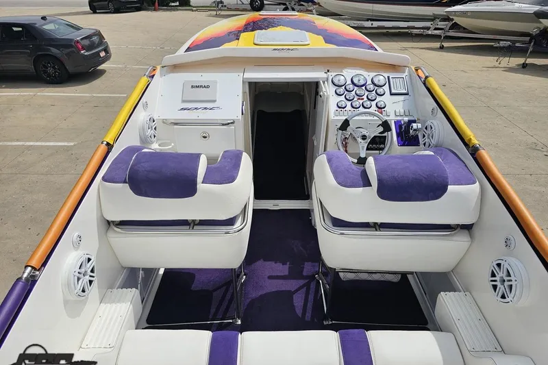 Slide: The Image of Interior of a 2003 Sonic USA 31SS speedboat with purple and white seating. - 51