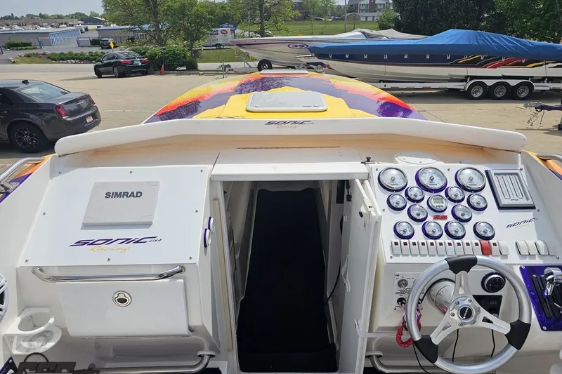 Slide: The Image of Cockpit view of a 2003 Sonic USA 31SS speedboat with vibrant dashboard and controls. - 53