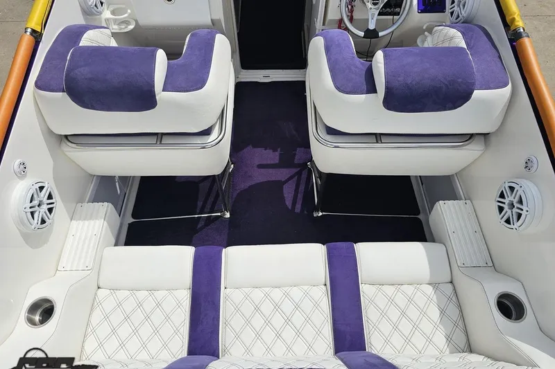 Slide: The Image of Interior of 2003 Sonic USA 31SS boat with purple and white seating. - 54