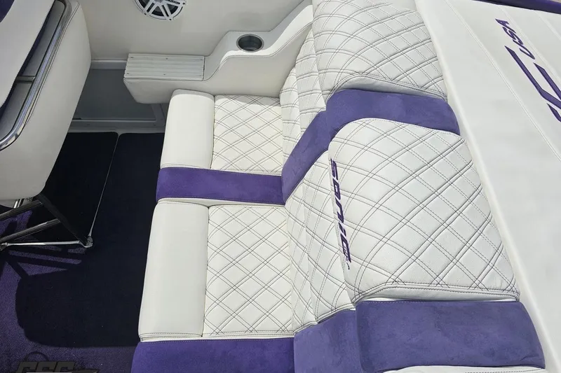Slide: The Image of Luxurious white and purple seating in 2003 Sonic USA 31SS boat interior. - 57