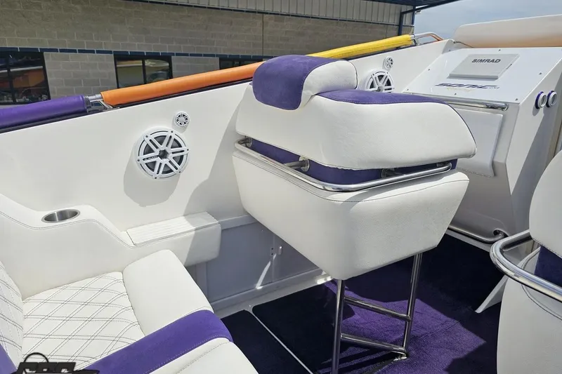 Slide: The Image of Interior of a 2003 Sonic USA 31SS boat with white and purple seating. - 59