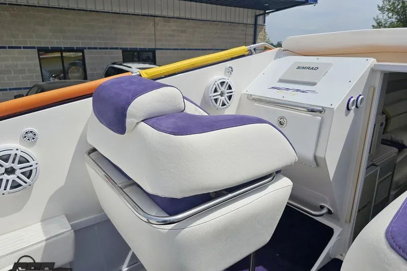 Slide: The Image of Interior of a 2003 Sonic USA 31SS boat with purple and white seating. - 60