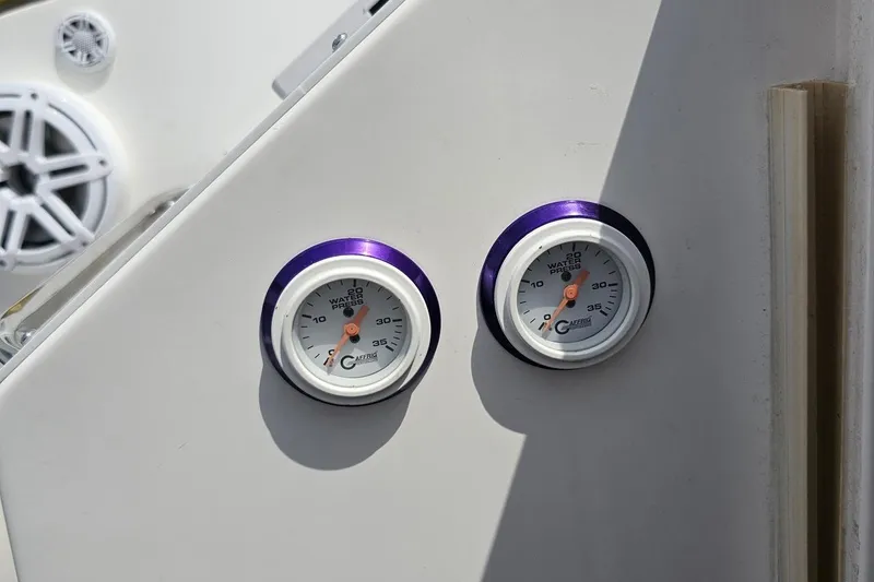 Slide: The Image of Two water pressure gauges on a 2003 Sonic USA 31SS boat dashboard. - 63