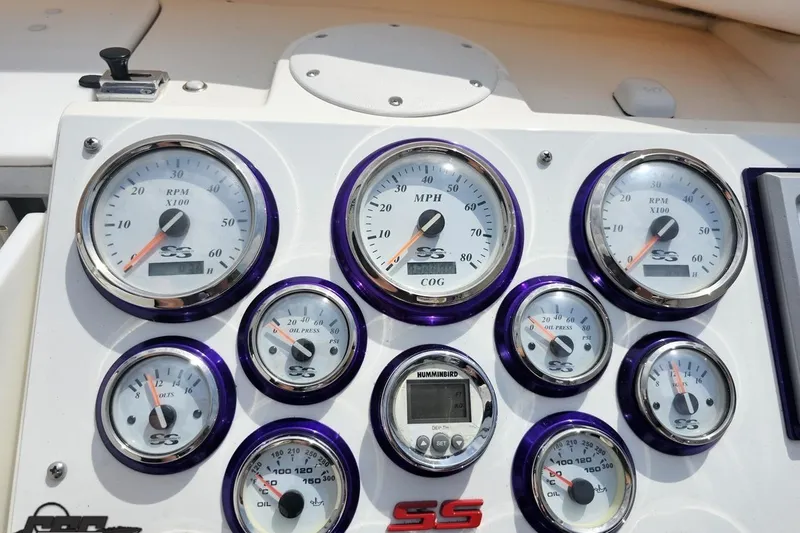 Slide: The Image of Dashboard of a 2003 Sonic USA 31SS boat with various gauges and dials. - 68