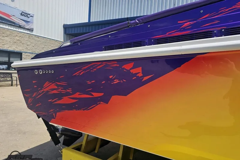 Slide: The Image of Colorful 2003 Sonic USA 31SS boat with vibrant purple and orange design. - 7