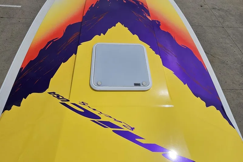 Slide: The Image of Colorful 2003 Sonic USA 31SS boat deck with vibrant graphics and hatch. - 72