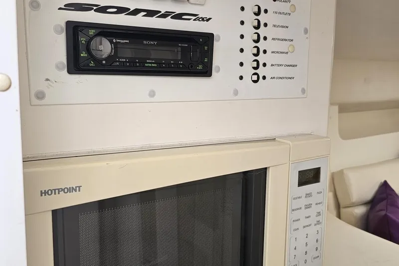 Slide: The Image of Control panel and Hotpoint microwave in a 2003 Sonic USA 31SS boat interior. - 78