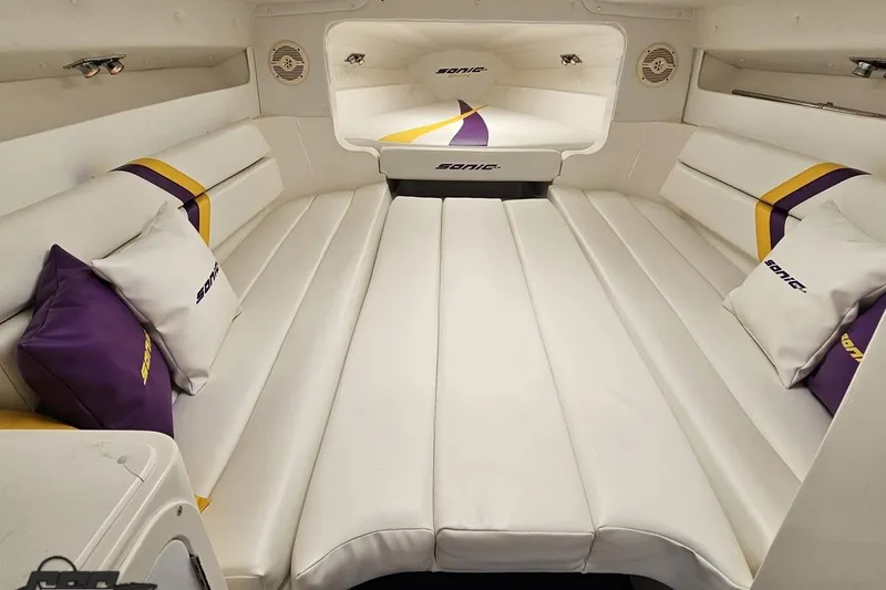 Slide: The Image of Luxurious interior of 2003 Sonic USA 31SS boat with white and purple seating. - 83